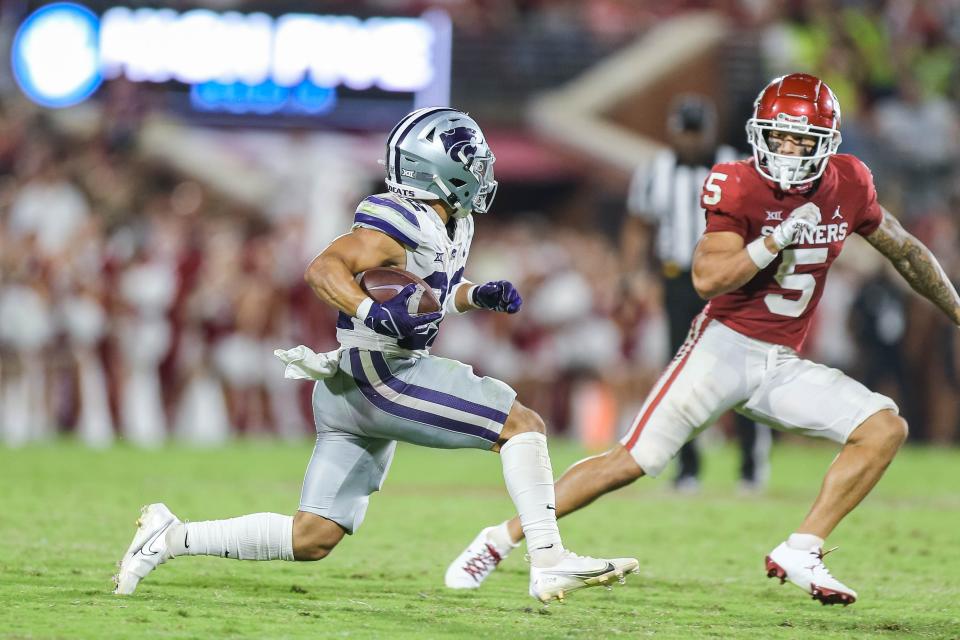 Kansas State's Deuce Vaughn (22) runs and is persued by Oklahoma's Billy Bowman (5) in the fourth quarter during a college football game between the University of Oklahoma Sooners (OU) and the Kansas State Wildcats at Gaylord Family - Oklahoma Memorial Stadium in Norman, Okla., Saturday, Sept. 24, 2022. Kasnas State won 41-34.