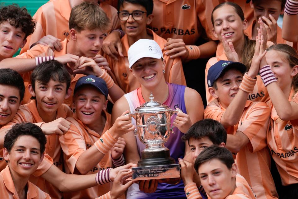 French Open champion Iga Swiatek with the ball children (AP)