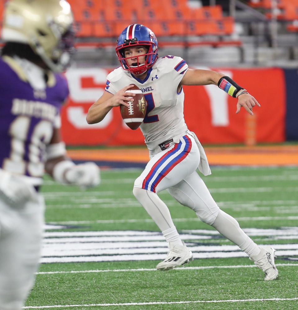 Carmel quarterback Christian Nunez (2) scrambles out of the pocket against Christian Brothers Academy during the New York State Class AA championship at the JMA Dome in Syracuse Dec. 3, 2023.