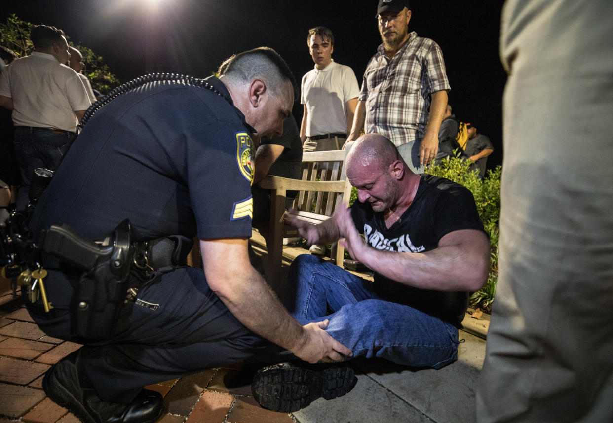 Christopher Cantwell is helped by police after being overcome with tear gas in Charlottesville, Va., Aug. 11, 2017. (Photo: Evelyn Hockstein for The Washington Post via Getty Images)