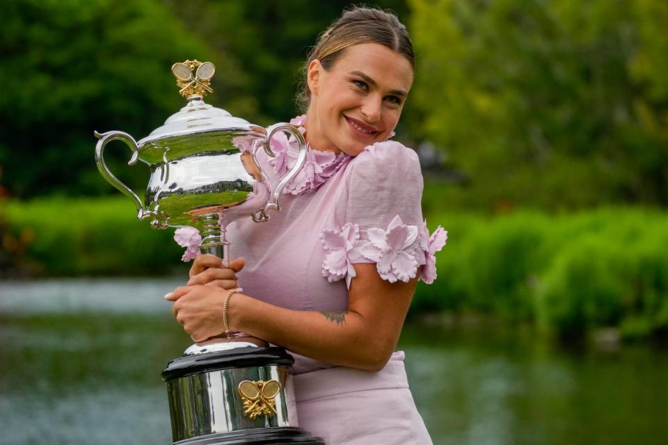 Aryna Sabalenka poses with the Daphne Akhurst Memorial Cup on Sunday (Aaron Favila/AP) (AP)