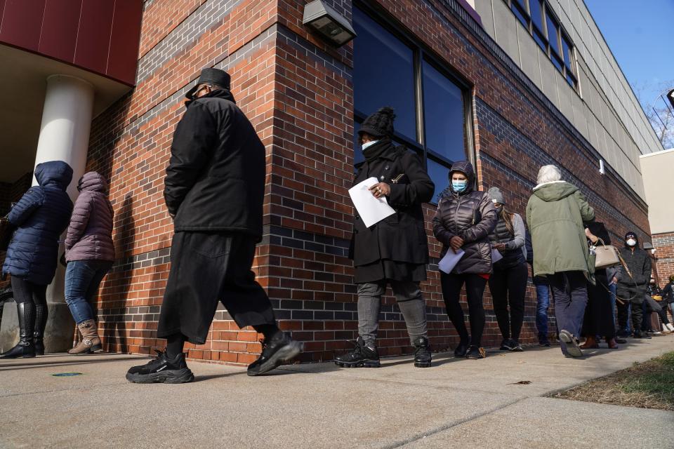 People wait in line to fill out an absentee ballot at the Sterling Heights Senior Center in Sterling Heights on November 2, 2020, for in-person absentee voting.