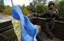 A Ukrainian serviceman uses his mobile phone as he rides on a military truck near the eastern Ukrainian town of Pervomaysk, September 17, 2014. REUTERS/David Mdzinarishvili