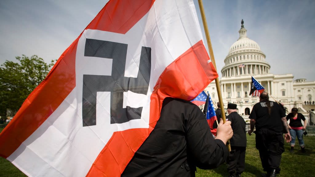  A man with a Nazi flag marches on the U.S. Capitol. 