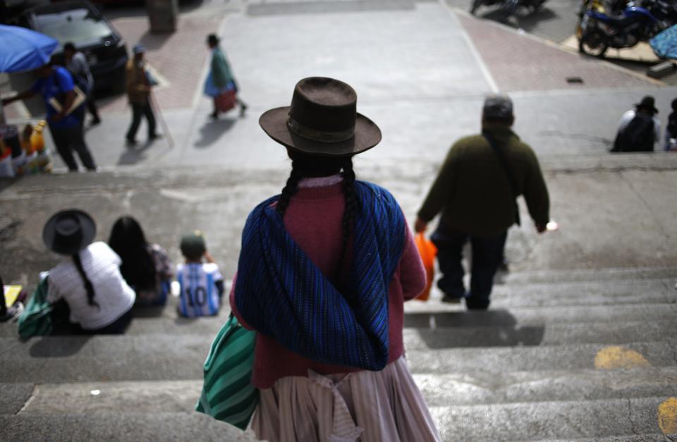 A woman descends a flight of steps in Ayacucho Peru, Tuesday, Dec. 20, 2022. Peru's Congress is slated to consider a proposal on Tuesday to push up elections that have been a major demand of protesters blocking highways and clashing with security forces in deadly demonstrations across the country over the ouster of President Pedro Castillo. (AP Photo/Hugo Curotto)