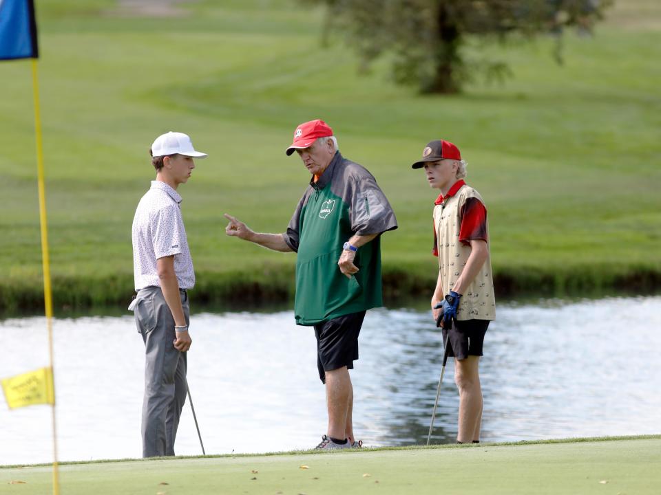 Garaway's Henry Swartzentruber, left, talks with a tournament official on the final hole of the Division III district golf tournament on Wednesday, Oct. 2, 2024, at River Greens in West Lafayette.