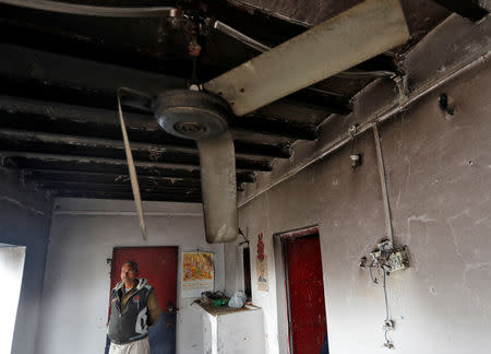 A policeman stands inside a corridor of the police station that was partially damaged by a mob during a protest on Monday, in Chingrawti village in Bulandshahr district, Uttar Pradesh, India December 5, 2018. REUTERS/Adnan Abidi