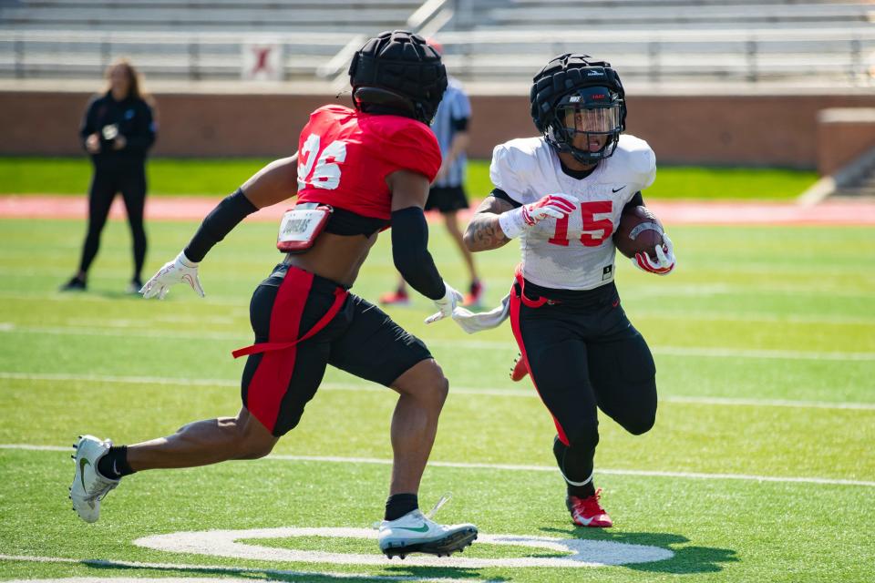 Ball State football running back Marquez Cooper (No. 15) and cornerback Jordan Coleman (No. 26) during the team's Spring Game at Scheumann Stadium on Saturday, April 8, 2023.