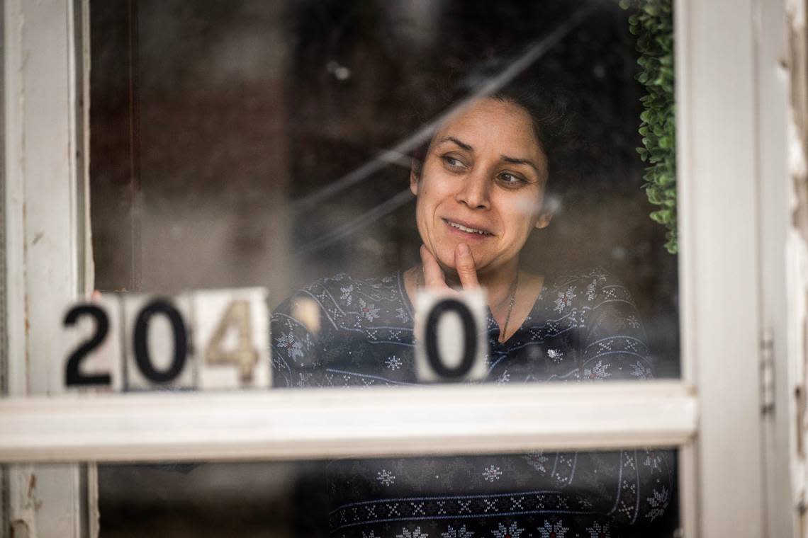 Adelaida Romero-Carlos, 42, watches her daughters play outside their rental unit at Clearview Village.
