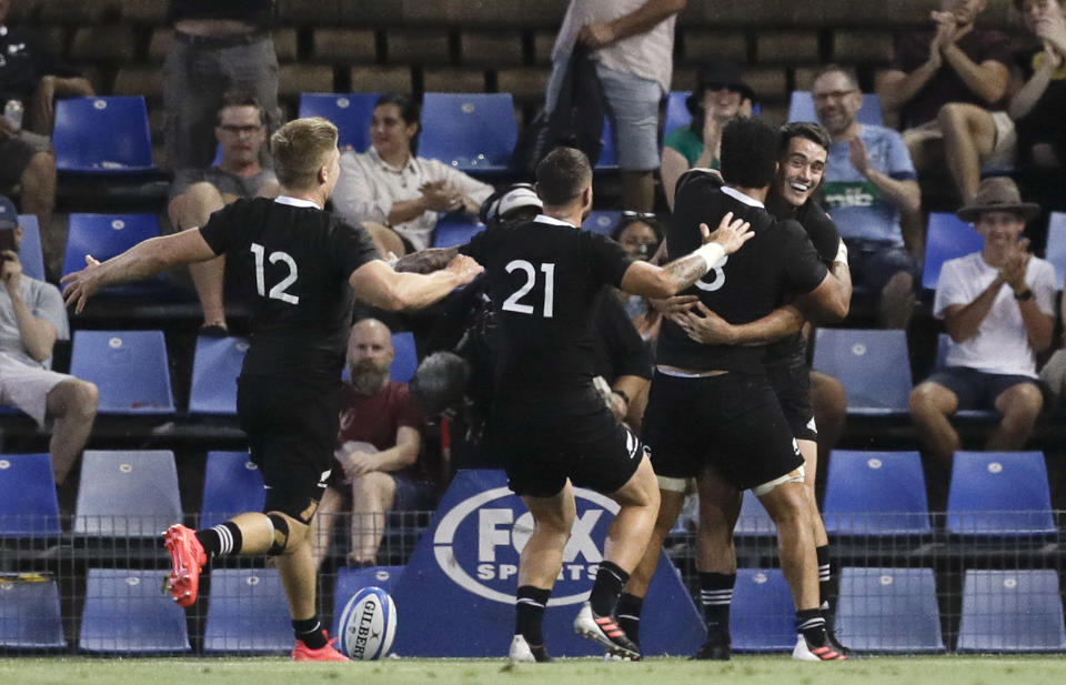 New Zealand's Will Jordan, right, is congratulated by teammates after scoring his second try during the Tri-Nations rugby test between Argentina and the All Blacks in Newcastle, Australia, Saturday, Nov. 28, 2020. (AP Photo/Rick Rycroft)