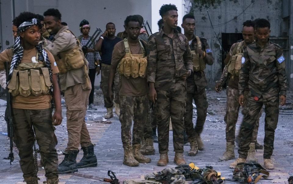 Police officers stand near bodies of alleged Al-Shabaab militants - Hassan Ali Elmi/AFP via Getty Images