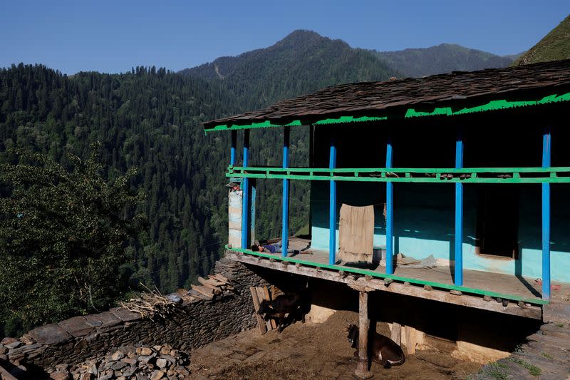 A boy sleeps outside his house in Almi, the village hosting a remote polling station, ahead of the seventh and final phase of the elections in the northern state of Himachal Pradesh