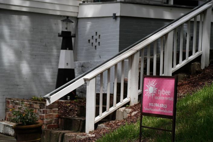 A replica of the Tybee Island Lighthouse sits at the entrance of a short term vacation rental on Tybee Island.