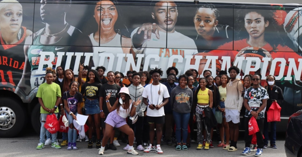 Students from Florida A&M University's TRIO Upward Bound Math and Science (UBMS) Program pose outside of their bus after a trip to iFly of Jacksonville.