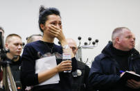 A Ukrainian International Airline company worker reacts during a briefing at Borispil international airport outside Kyiv, Ukraine, Wednesday, Jan. 8, 2020. A Ukrainian airplane carrying 176 people crashed on Wednesday shortly after takeoff from Tehran's main airport, killing all onboard, Iranian state TV and officials in Ukraine said. (AP Photo/Efrem Lukatsky)