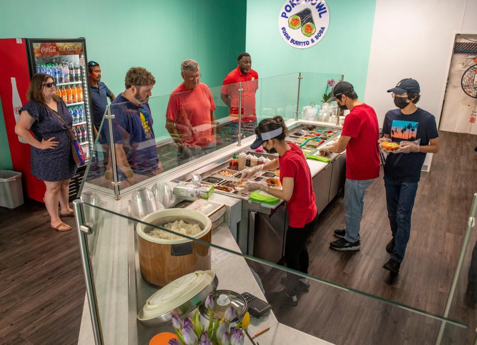 Customers order lunch at Poke Bowl Sushi Burrito and Boba in Gulf Breeze Sunday, May 15, 2022.