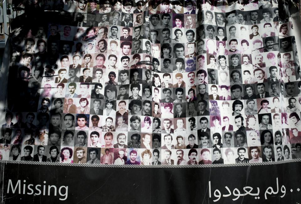 A banner shows small portraits of people reported missing during the Lebanese civil war and aftermath, during the ninth anniversary of an ongoing sit-in, in front the U.N headquarters in downtown Beirut, Lebanon, Friday April 11, 2014. An estimated 17,000 Lebanese are still missing from the time of Lebanon’s civil war or the years of Syrian domination that followed. Syria’s civil war has added new urgency to the plight of their families, many of whom are convinced their loved ones are still alive and held in Syrian prisons, at risk of being lost or killed in the country’s mayhem. (AP Photo/Hussein Malla)