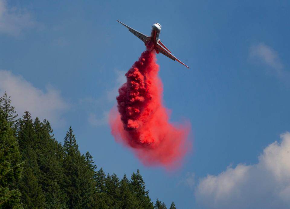 A tanker plane drops a load of fire retardant on the top of Dead Mountain to protect electronic equipment arrays stationed there as the Salmon Fire burns a few miles to the east.