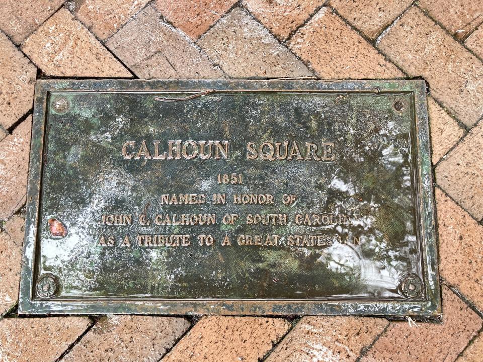 A plaque dedicating Calhoun Square in honor of former U.S. Vice President John C. Calhoun is embedded among the square's bricks in the downtown historic district of Savannah, Ga., Thursday, Nov. 10, 2022. The Savannah City Council voted to remove Calhoun's name from the square, citing his history as an outspoken slavery advocate in the decades preceding the Civil War. The move comes two years after a statue of Calhoun was taken down in Charleston, S.C. Savannah officials say the square that bore Calhoun's name for more than 170 years will be renamed later. (AP Photo/Russ Bynum)