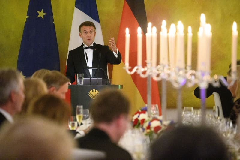 French President Emmanuel Macron speaks at the state banquet in honor of the Macron and his wife at Bellevue Palace. Bernd von Jutrczenka/dpa