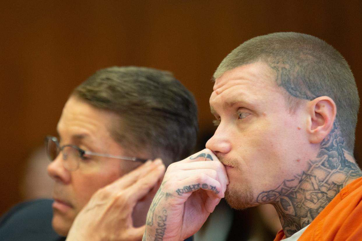 Defendant Eric Perkins talks quietly to defense attorney James Landis Spies during Monday's preliminary hearing at the Shawnee County Courthouse.