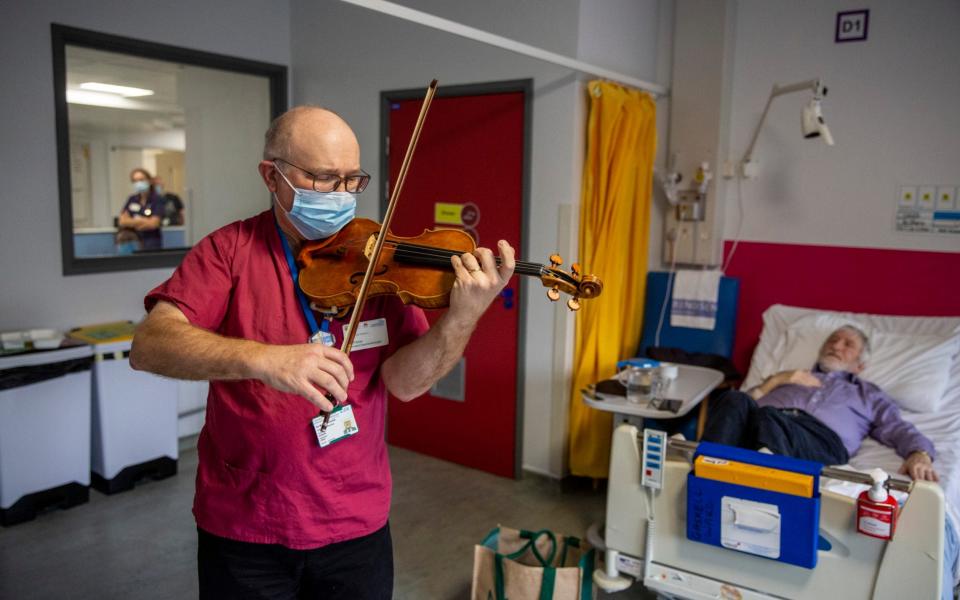 Dr Maxton Pitcher, a Consultant Gastroenterologist at Northwick Park Hospital London ,has been playing his violin for the benefit of patients and hospital staff since the pandemic began - Telegraph/Heathcliff O'Malley