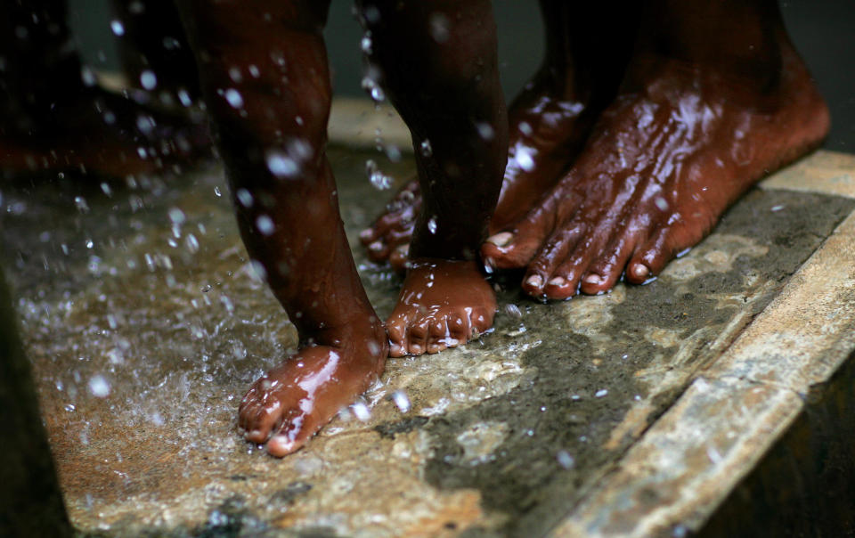 A mother washes her child in the Mahmoud Ladies School which is being used as a refugee shelter for homeless tsunami families. A mother washes her child in the Mahmoud Ladies School which is being used as a refugee shelter for homeless tsunami families in Kalmunai on Sri Lanka's east coast January 10, 2005. The death toll from the Asian tsunami, triggered by a magnitude 9.0 earthquake off Indonesia on December 26, stood at 156,193 people, government and health officials said.