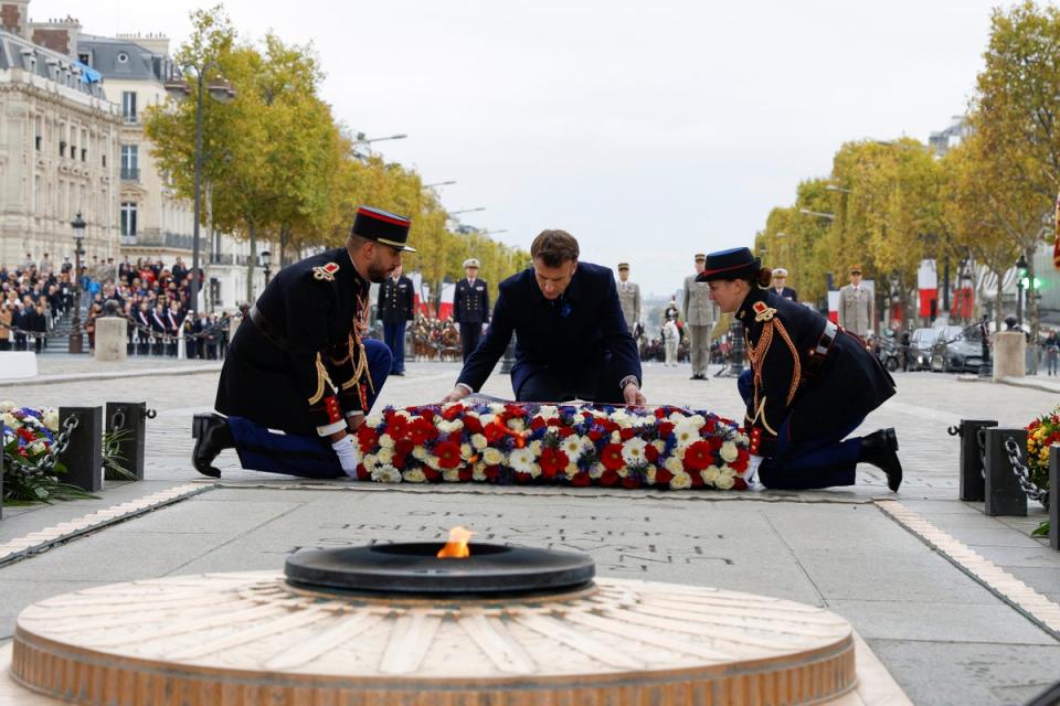 French President Emmanuel Macron lays a wreath at the Tomb of the Unknown Soldier during a ceremony at the Arc de Triomphe, as part of the commemorations marking the 104th anniversary of the Nov. 11, 1918 Armistice, ending World War I, (AP)