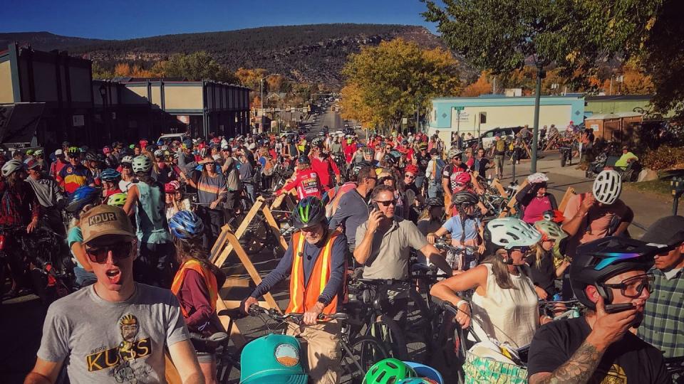 a large group of people riding bikes