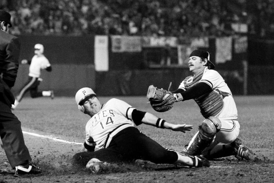 FILE - Pittsburgh Pirates' Ed Ott slides across home late out of reach of Orioles catcher Rick Dempsey to score the winning run in the ninth inning of Game 2 of the World Series at Baltimore, Oct. 11, 1979. Ott, a former major league catcher and coach who helped the Pirates win the 1979 World Series, died Sunday, March 3, 2024. (AP Photo, File)