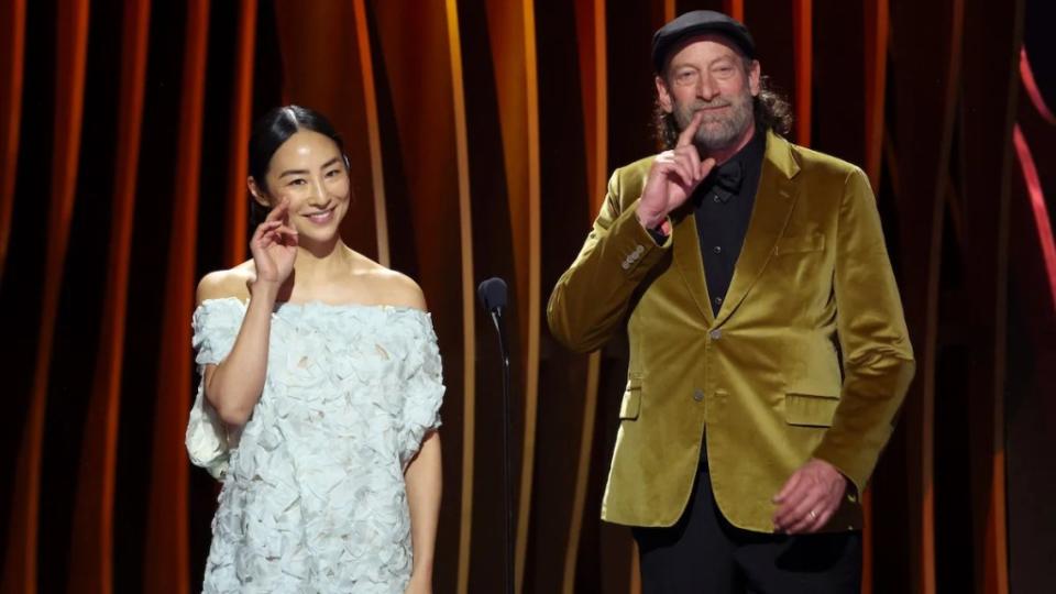 Greta Lee and Troy Kotsur speak onstage during the 30th Annual Screen Actors Guild Awards