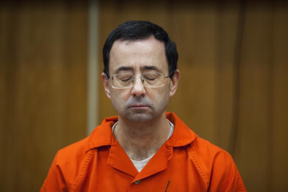 FILE - Larry Nassar listens during his sentencing at Eaton County Circuit Court in Charlotte, Mich., Feb. 5, 2018. Nassar, who was convicted of sexually abusing female gymnasts including Olympic medalists, was stabbed multiple times during an altercation with another inmate at a federal prison in Florida on Sunday, July 9, 2023. (Cory Morse/The Grand Rapids Press via AP, File)