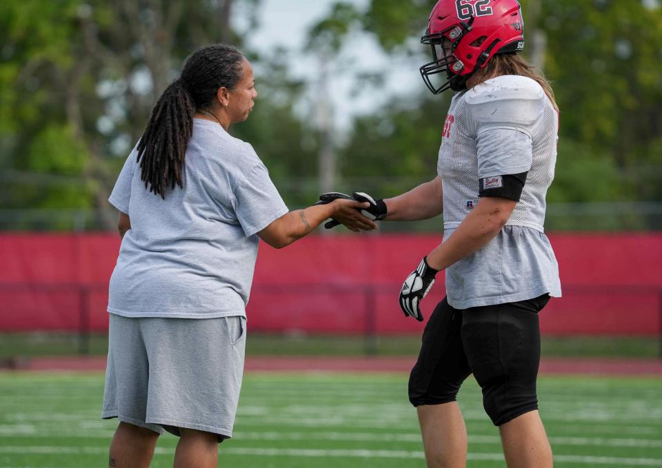 Des Moines East assistant coach Renate Rice talks to one of her players during a preseason practice earlier this month