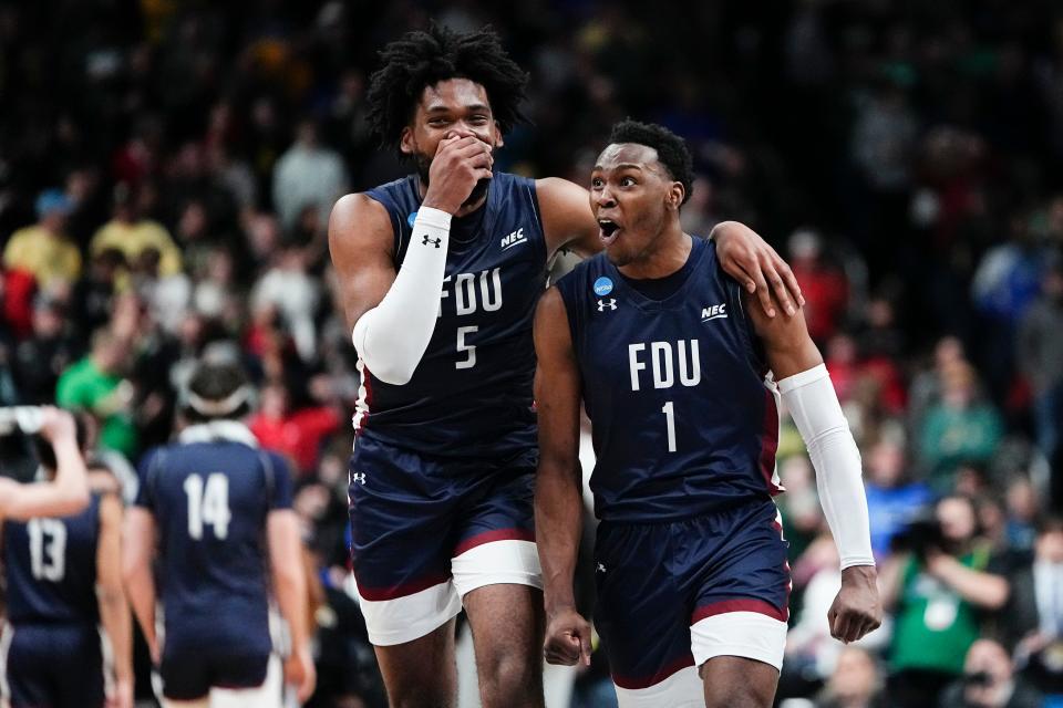 Fairleigh Dickinson Knights guard Joe Munden Jr. (1) and forward Ansley Almonor (5) celebrate their 63-58 win over the No. 1 seed Purdue Boilermakers during the first round of the NCAA men’s basketball tournament at Nationwide Arena. FDU was the No. 16 seed.