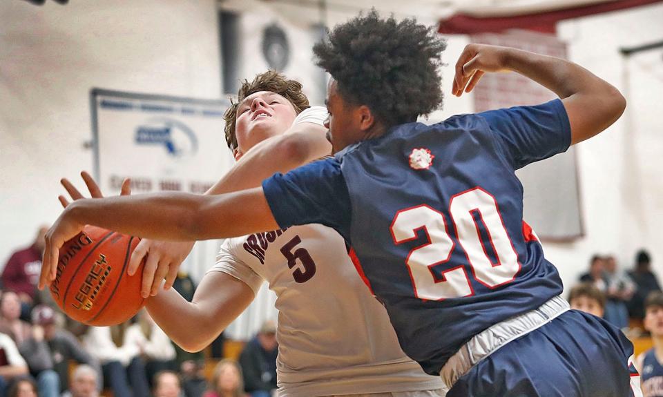 Crusader Jack Balzarini gets fouled by Rocklands Daniel Johnson during a lay up.The Carver Crusaders hosted Rockland Bulldogs boys basketball in MIAA action on Friday February 10, 2023 