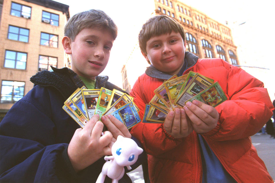 Two children display their Pokemon cards in New York city November 12, 1999. In anticipation of the overwhelming demand for the new limited edition Pokemon trading cards being given away in conjunction with the November 10 release of Kids'' WB! Presents 