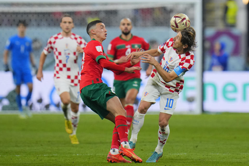 Morocco's Bilal El Khannous, left, and Croatia's Luka Modric fight for the ball during the World Cup third-place playoff soccer match between Croatia and Morocco at Khalifa International Stadium in Doha, Qatar, Saturday, Dec. 17, 2022. (AP Photo/Hassan Ammar)