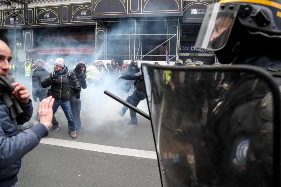 Protesters clash with police forces during a yellow vest demonstration in Paris (AFP/Getty Images)