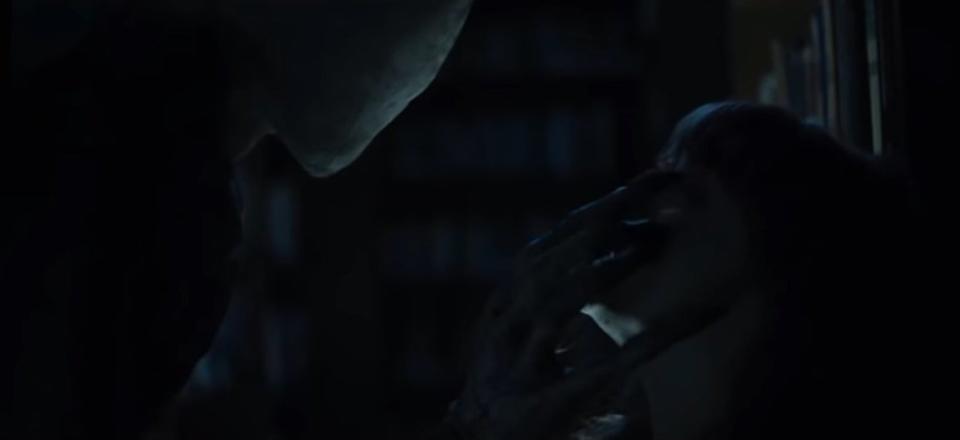 Slender Man grabbing onto Chloe's face in "Slender Man"