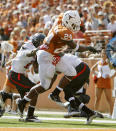 AUSTIN, TX - NOVEMBER 5: Running back Joe Bergeron #24 of the Texas Longhorns gets past defensive back Shawn Corker #9 and safety Shawn Phillips #12 of the Texas Tech Red Raiders to score a fourth quarter touchdown on November 5, 2011 at Darrell K. Royal-Texas Memorial Stadium in Austin, Texas. Texas beat Texas Tech 52-20. (Photo by Erich Schlegel/Getty Images)