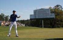 Jordan Spieth of the U.S. tosses his ball to his caddie on the 18th green in third round play during the 2017 Masters golf tournament at Augusta National Golf Club in Augusta, Georgia, U.S., April 8, 2017. REUTERS/Brian Snyder