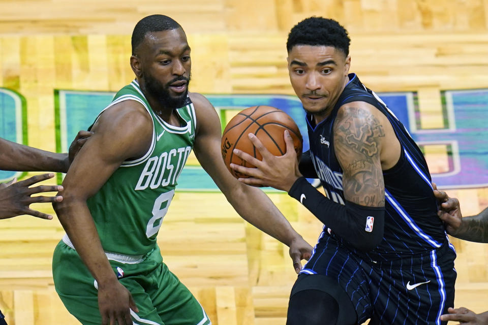 Orlando Magic guard Gary Harris, right, makes a move to get past Boston Celtics guard Kemba Walker (8) during the first half of an NBA basketball game, Wednesday, May 5, 2021, in Orlando, Fla. (AP Photo/John Raoux)