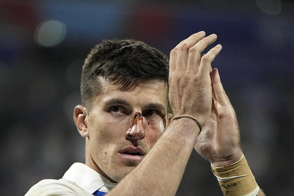 Italy's Tommaso Allan applauds as he walks around the pitch after the Rugby World Cup Pool A match between France and Italy at the OL Stadium, in Lyon, France Friday, Oct. 6, 2023. (AP Photo/Laurent Cipriani)