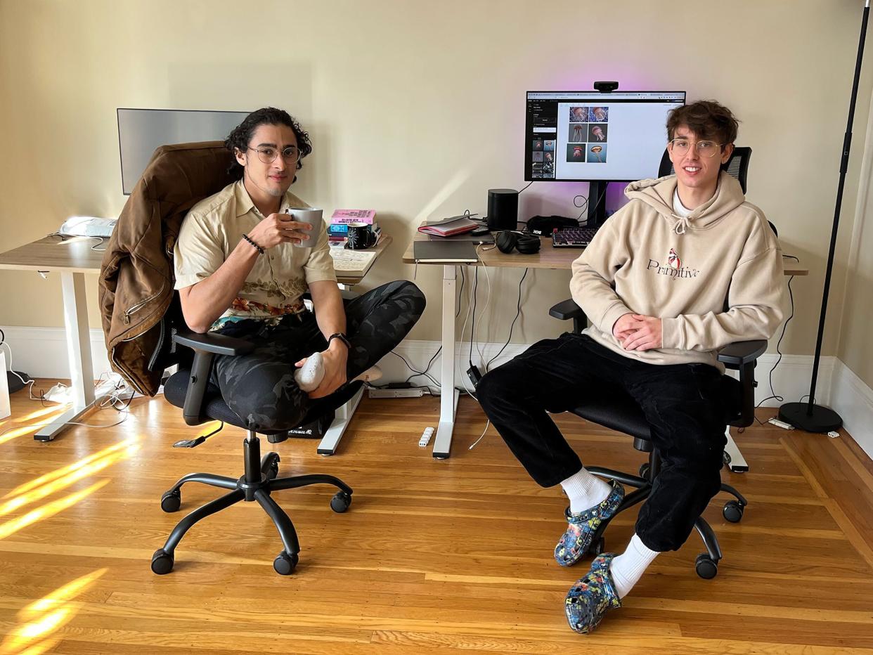 Picture of KREA co-founders Victor Perez and Diego Rodríguez sitting in front of their computers.