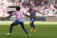 AC Milan's Christian Pulisic, right, celebrates with his teammate Samuel Chukwueze after scoring his side's opening goal during the Serie A soccer match between AC Milan and Lecce at the San Siro stadium, in Milan, Italy, Saturday, April 6, 2024. (AP Photo/Antonio Calanni)