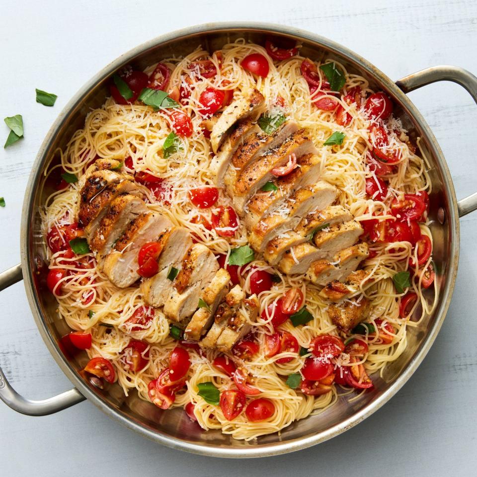 bruschetta chicken pasta topped with fresh herbs and parmesan