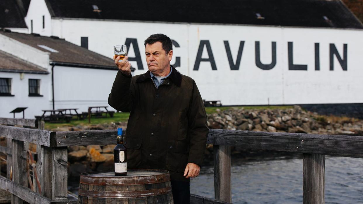 a man holding a glass of beer