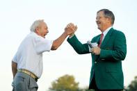 <p>Augusta National Golf Club chairman William Porter Payne (L) high fives honorary starter Arnold Palmer after his tee shot on the first hole during the start of first round of the 2012 Masters Tournament at Augusta National Golf Club on April 5, 2012 in Augusta, Georgia. (Photo by Streeter Lecka/Getty Images) </p>