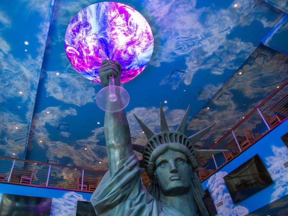 the Statue of Liberty holding a glowing glass