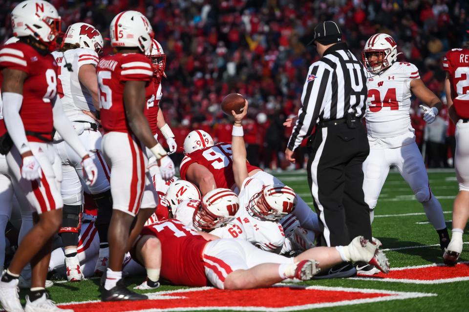 Wisconsin quarterback Graham Mertz raises the ball after scoring on a game-winning 1-yard sneak against the Nebraska Cornhuskers with 35 seconds remaining. The touchdown gave the Badgers a 15-14 lead.